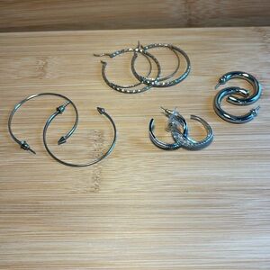 Bundle of 4 pairs pierced silver tone hoop earrings.